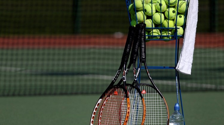 Tennis rackets with tennis balls on a court