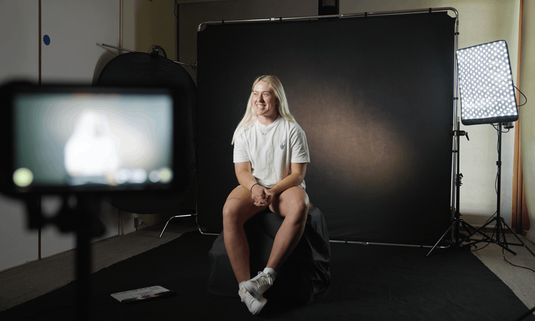 Sonay Kartal sat in front of a black screen whilst filming for Beyond the Baseline, presented by Lexus