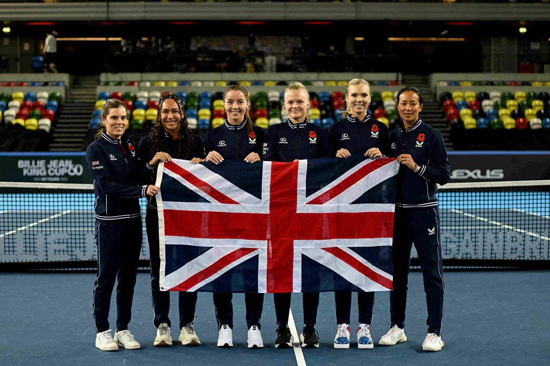 Maia Lumsden, Heather Watson, Jodie Burrage, Harriet Dart, Katie Boulter and Anne Keothavong stood on court in their Lexus GB kit holding the flag of Great Britain