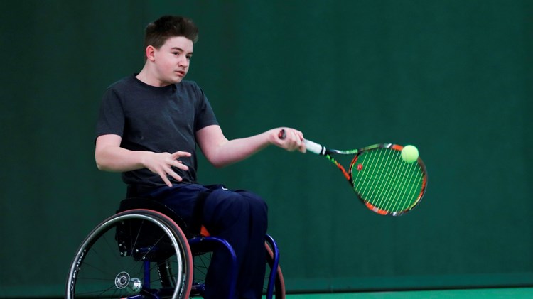 Ruairi Logan hitting a forehand