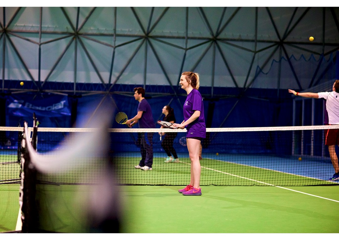 Emma playing on an indoor court
