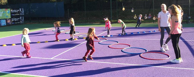 LTA regional award winner Maggie coaching kids
