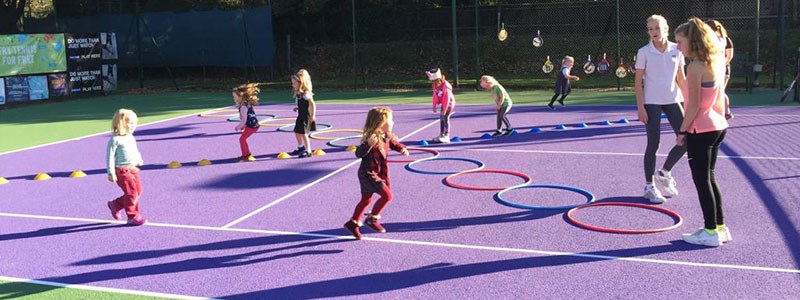 LTA regional award winner Maggie coaching kids