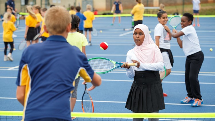 Young boy and girl playing tennis at the tennis festival in Bristol