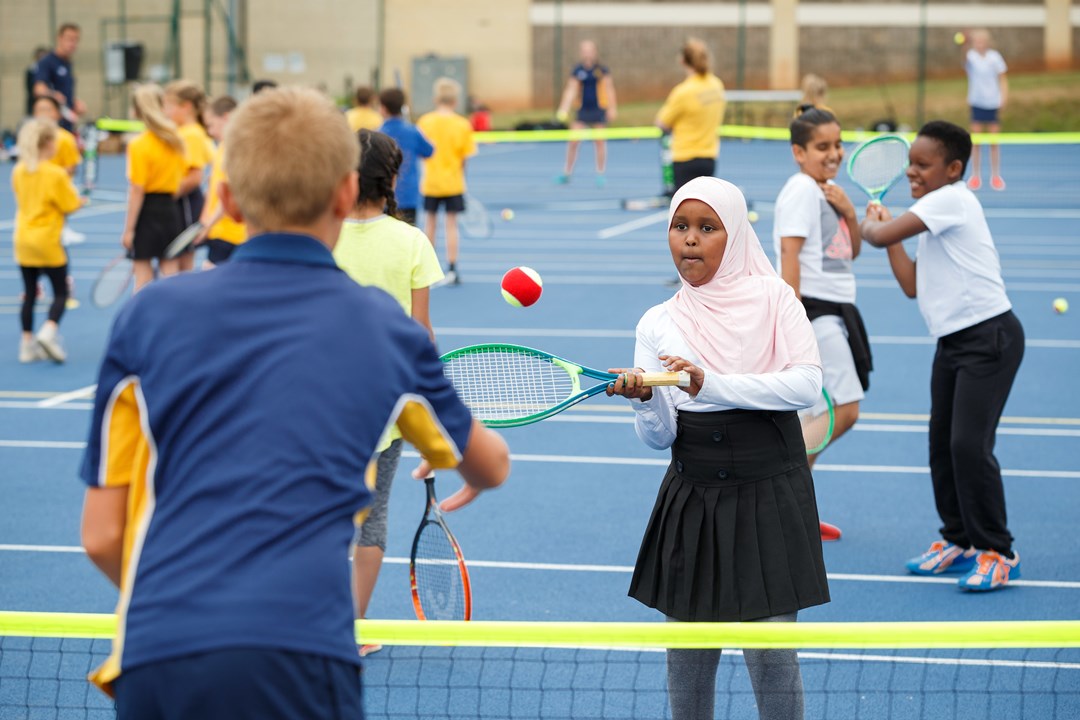 Young boy and girl playing tennis at the tennis festival in Bristol