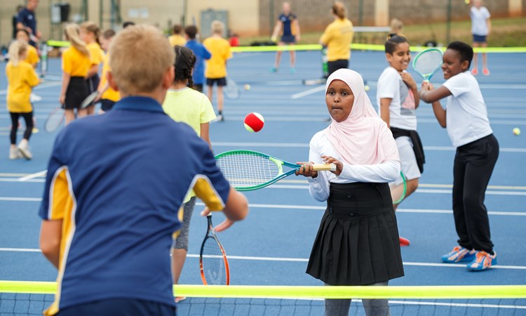 Young boy and girl playing tennis at the tennis festival in Bristol