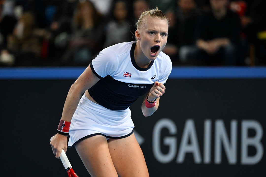 Harriet Dart roars in celebration and clenches her fist on court at the Billie Jean King Cup