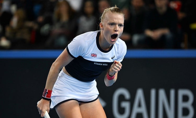 Harriet Dart roars in celebration and clenches her fist on court at the Billie Jean King Cup