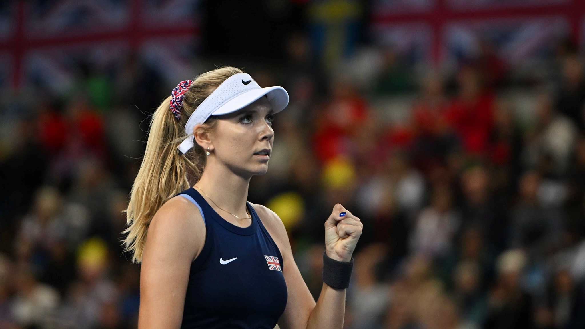 Katie Boulter clenches her fist in celebration on court at the Billie Jean King Cup