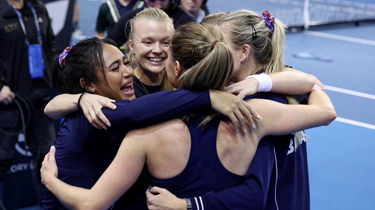 The Bille Jean King Cup squad hug after defeating Spain to reach the semi-finals