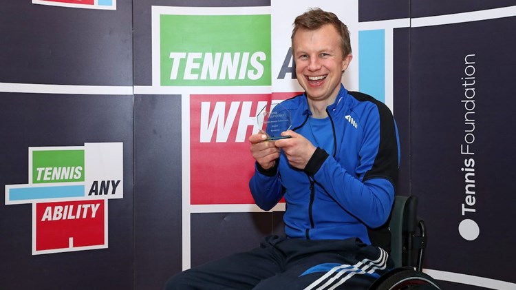 Philip holding his award