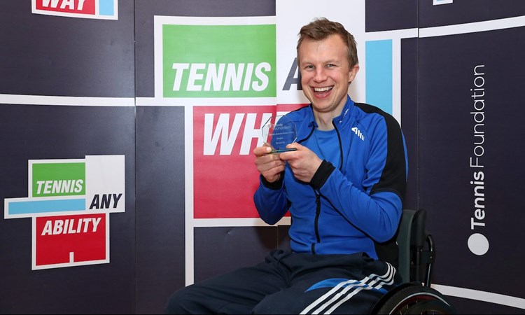 Philip holding his award