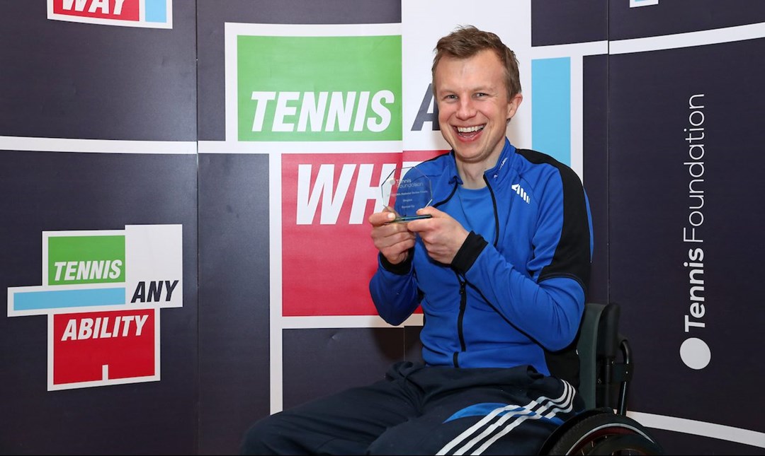 Philip holding his award