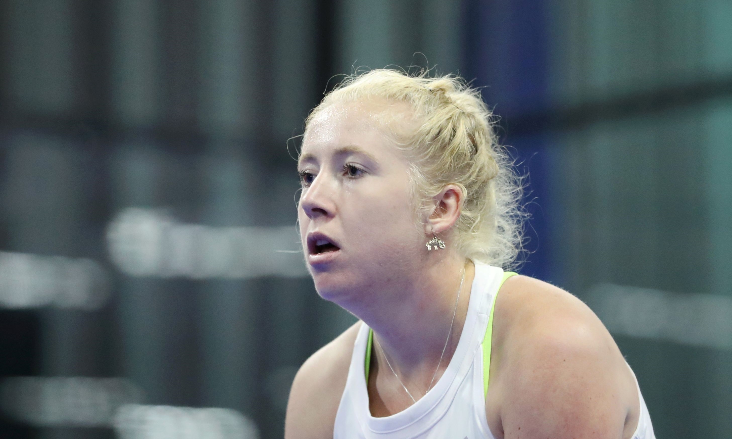 A close up picture of British Padel player Lisa Phillips wearing a white top with a flag of Great Britain