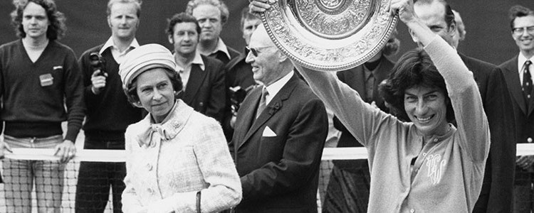 black and white image of virginia wade holding winners trophy and the queen on the left of her