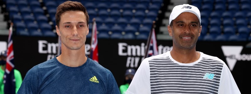 Joe Salisbury and Rajeev Ram smiling on a tennis court