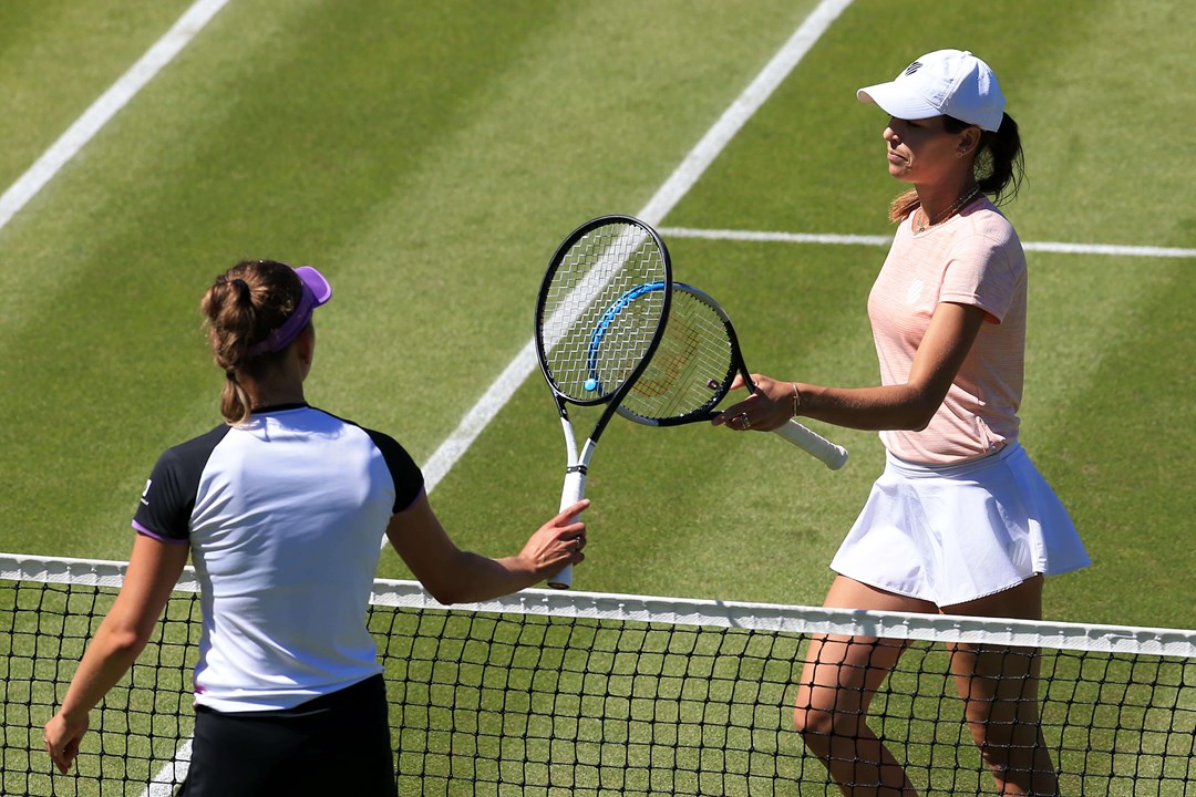 Elise Mertens and Ajla Tomljanović at the tennis net