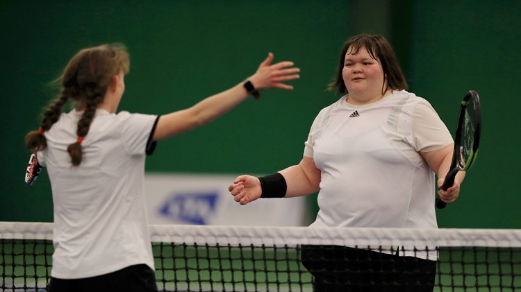 Rosie Pybus meets Lydia Wrightson at the net after a matc at the Visually Impaired Finals