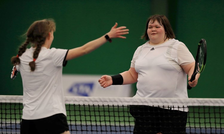 Rosie Pybus meets Lydia Wrightson at the net after a matc at the Visually Impaired Finals