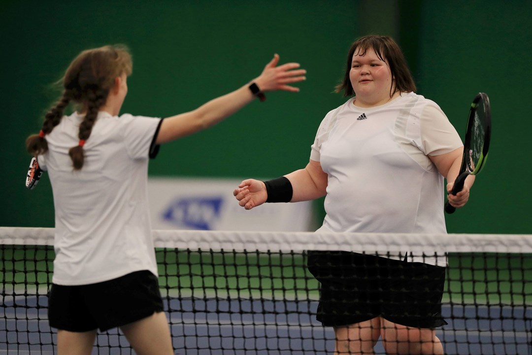 Rosie Pybus meets Lydia Wrightson at the net after a matc at the Visually Impaired Finals