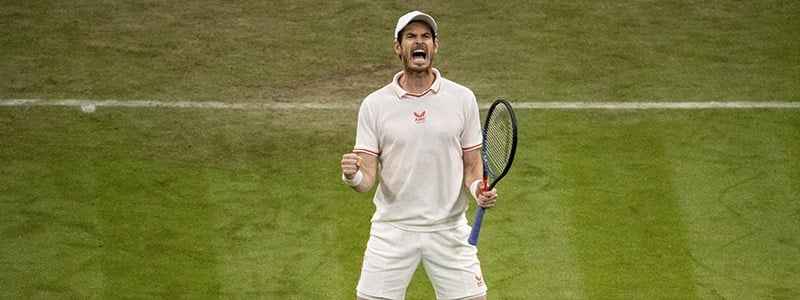 Andy Murray celebrating on a tennis court with his tennis gear