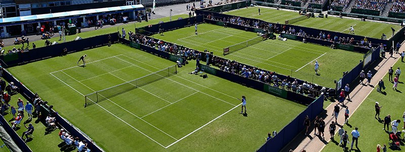 birds eye view of three of wimbledons grasscourts with singles matches being played on all courts