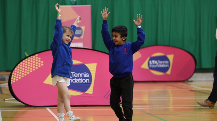 Two kids playing tennis at an LTA Tennis Foundation festival