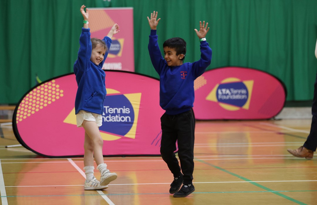 Two kids playing tennis at an LTA Tennis Foundation festival