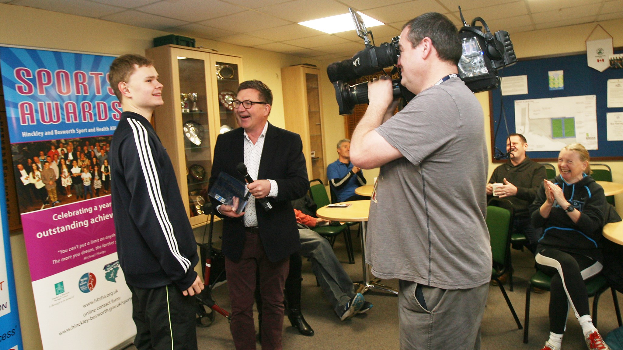 Matt being presented with his trophy infront of a camera