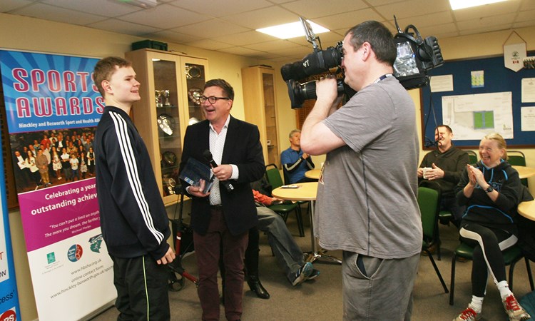 Matt being presented with his trophy infront of a camera