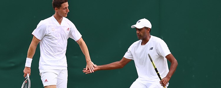 Joe Salisbury and Rajeev Ram high-fiving in a game of tennis