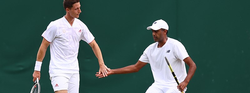 Joe Salisbury and Rajeev Ram high-fiving in a game of tennis