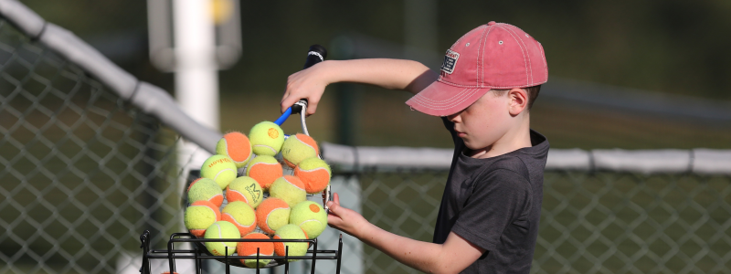 child-with-tennis-balls.png