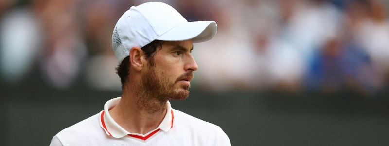 Andy Murray looking to his left in front of a blurred out crowd