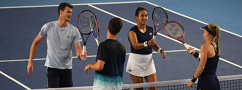 Players touching rackets over the net before a match