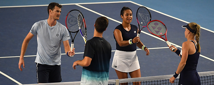 Players touching rackets over the net before a match
