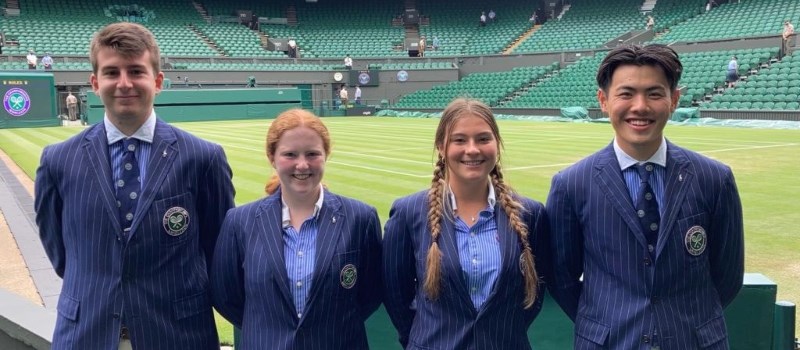 four new officials for the 134th championship standing in front of a Wimbledon tennis court