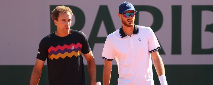 Jamie Murray in sunglasses with Bruno Soares on a tennis court