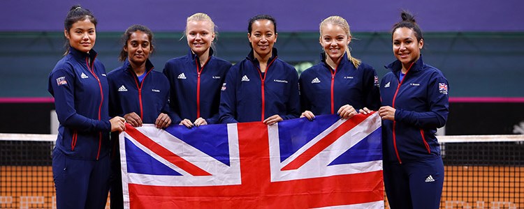 GB Fed cup team holding the flag