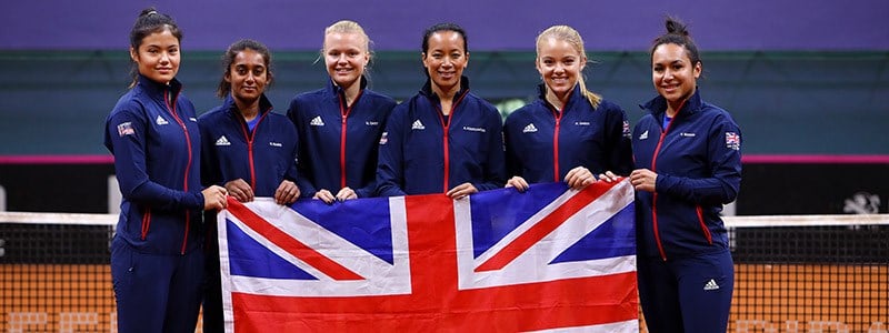 GB Fed cup team holding the flag