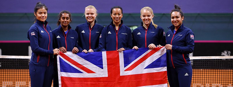 GB Fed cup team holding the flag