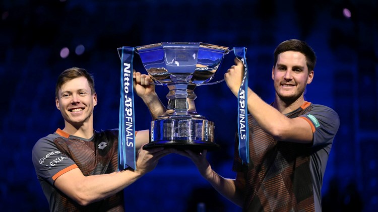 Harri Heliovaara and Henry Patten holding the 2025 Nitto ATP Finals title