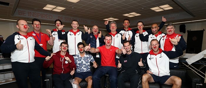british tennis team committee members with red button sports relief noses on and all doing a thumbs up