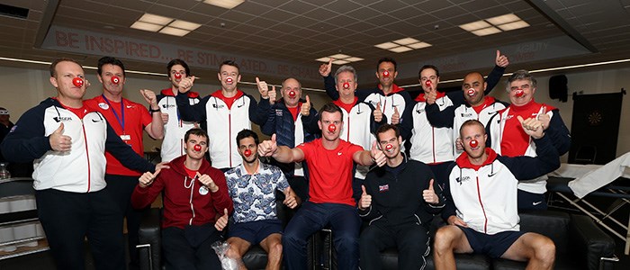 british tennis team committee members with red button sports relief noses on and all doing a thumbs up