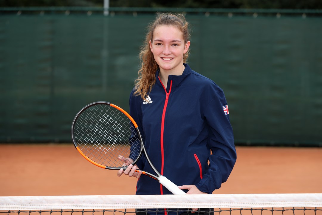 Phoebe Suthers smiling holding tennis racket