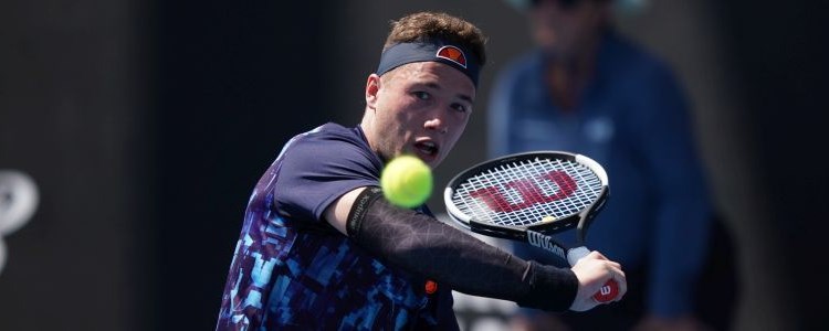 Alfie Hewett on court about to hit a backhand shot