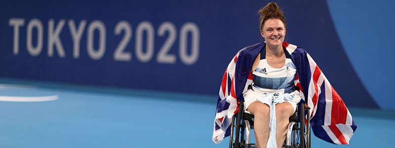 jordanne whiley on court with big GB flag around her
