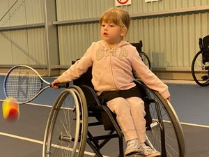 Young girl in wheelchair about to take a shot