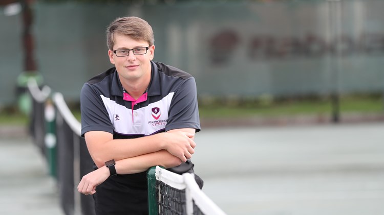 Conor Evans leaning on a net