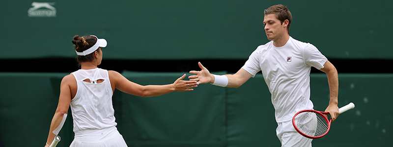 Neal Skupski and Desirae Krawcyzk high-fiving at 2021 Wimbledon